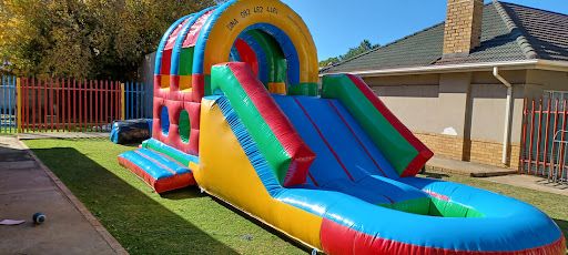 Rainbow water slide inflatable obstacle course rental